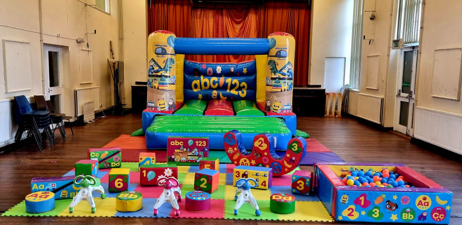 Low height indoor bouncy castle with soft play setup in Stockport venue